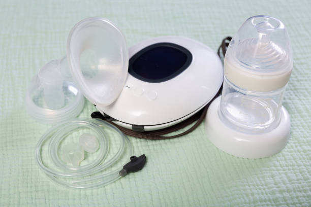 istock Electric mini breast pump lying on cloth 1479856187
