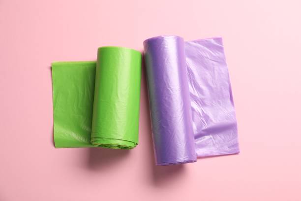istock Rolls of different garbage bags on pink background, flat lay 1479856688