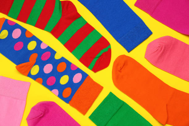 istock Many different colorful socks on yellow background, flat lay 1479856691