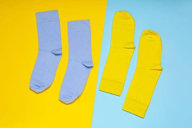 istock Blue and yellow socks on color background, flat lay 1479856693