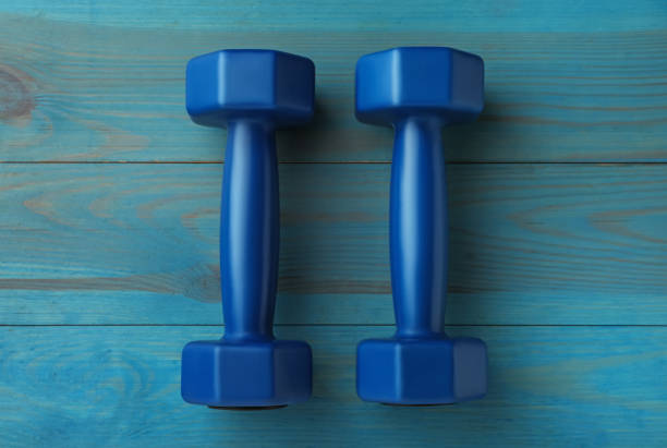 istock Blue dumbbells on turquoise wooden table, flat lay 1479856815