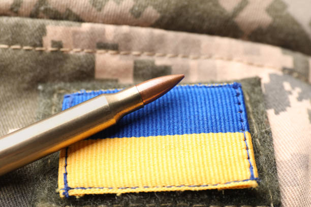 istock Bullet and Ukrainian army patch on military camouflage, closeup 1479856847