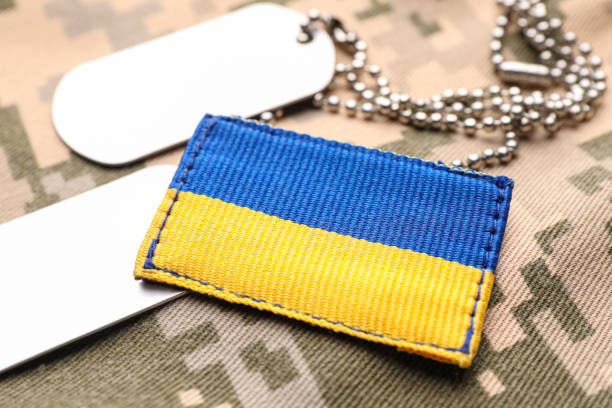 istock Military ID tags and patch on pixel Ukrainian camouflage, closeup 1479856848
