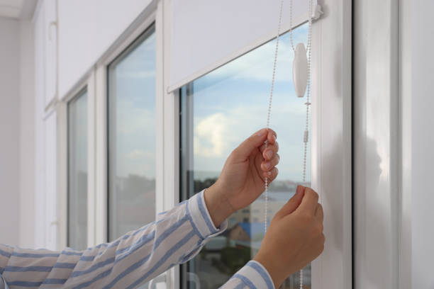woman opening white roller blinds on window indoors, closeup - sunblinds imagens e fotografias de stock