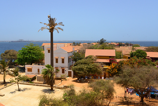 Gorée Island, Dakar, Senegal: panoramic view of the town's rooftops from Castel hill. Dakar on the horizon.
