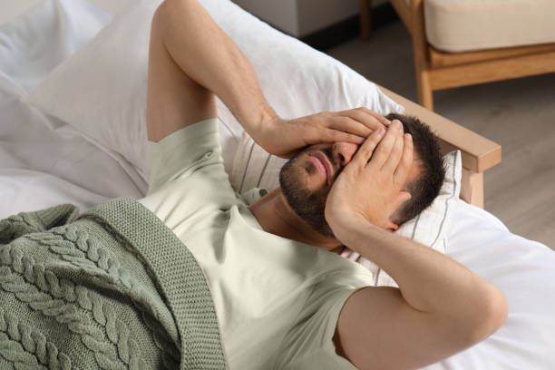 istock Sleepless man lying in bed at home 1479858838