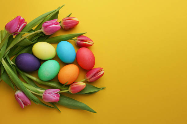 istock Fresh colorful tulip flowers and easter eggs on yellow background. Top view with copy space. Happy easter greeting card. 1479859001