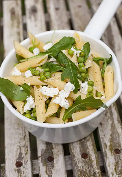 Healthy pasta dish with penne, goatcheese and rocket