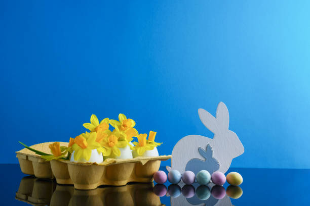 istock Happy Easter holiday background concept. Easter decoration with flowers in egg shells, bunny and sweet eggs. Creative easter layout. Copy space 1479860770