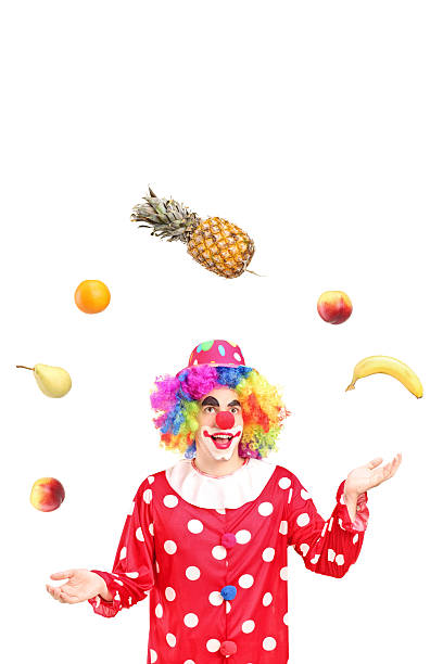 istock Smiling clown juggling fruits 147986285