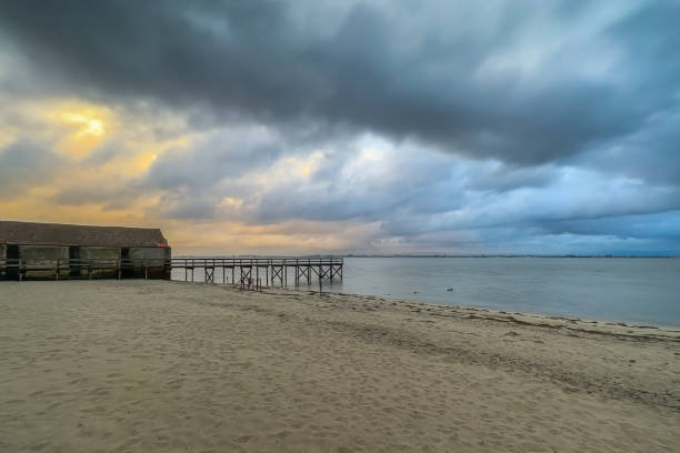 istock Empty wooden pier with dramatic sky and calm water 1479872264