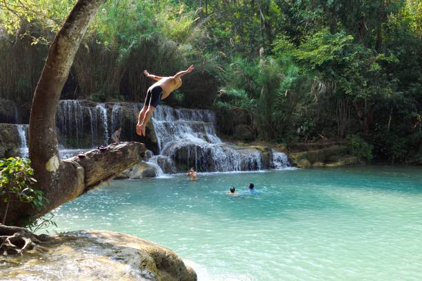 Luang Prabang, Laos.　\nThe entire ancient city of Luang Prabang is a World Heritage Site.\nkwang si waterfall about 200 meters high, positive triangle, from the mountain down, quite spectacular, coupled with the surrounding vegetation is very beautiful, become Luang Prabang's most famous tourist mecca.\nForeign tourists come here to play in the water every day.