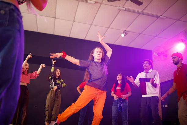 istock Long haired man dancing and being cheered by his friends 1479875052