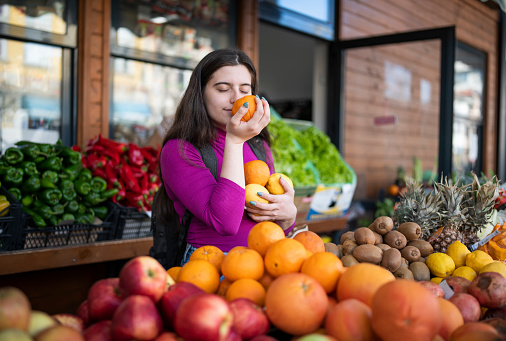 Young woman shopping for groceries from a local farmer's market.