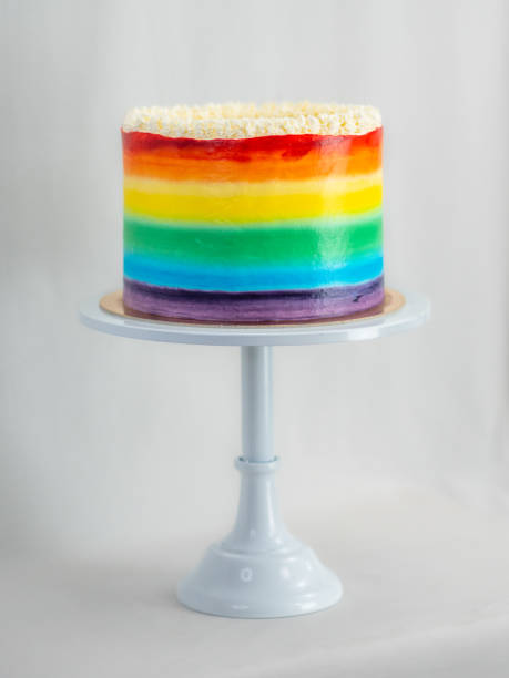 istock chef pastry baker making a frosted cup cake with rainbow colors - lgbt pride celebration anniversary 1479881637