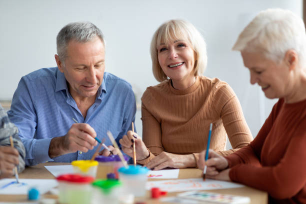 istock Creative senior people enjoying painting class at sanatorium 1479884363
