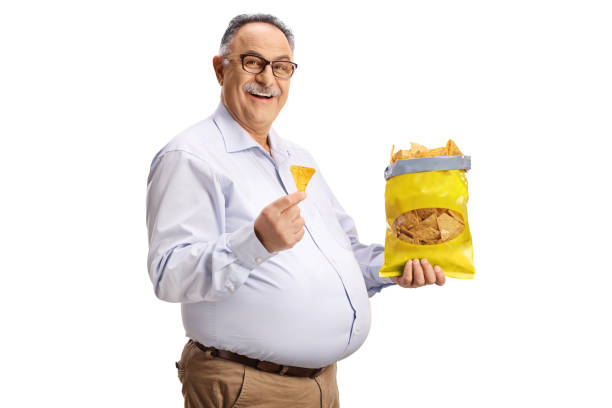 istock Cheerful mature man eating tortilla crisps and smiling 1479884549