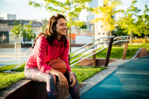 Portrait of a happy girl going to play basketball stock photo