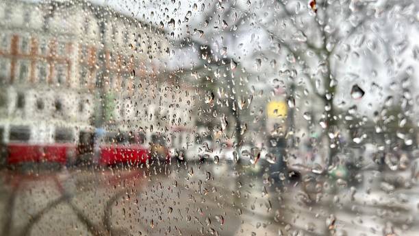 istock rain drops on window over street in city 1479887531