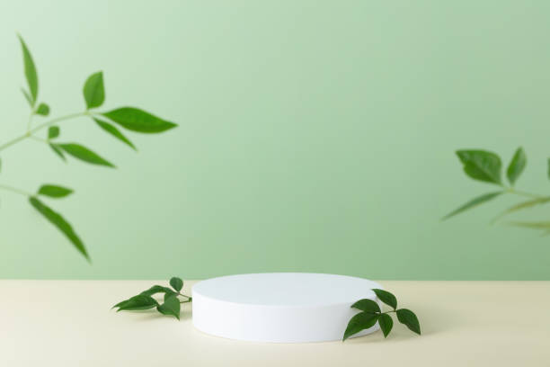 istock Abstract empty white podium with palm leaves on beige background 1479888130