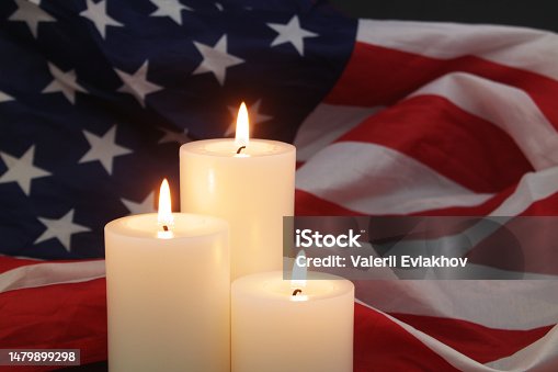 istock Burning candles on USA flag background. 1479899298