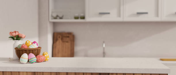 istock Copy space on a white kitchen tabletop with Easter eggs and wicker basket in a modern white kitchen 1479907590