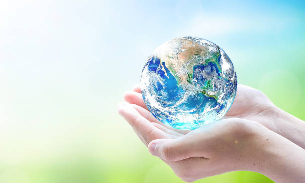 istock world environment and earth day, Human hands holding earth globe over blurred green and blue sky nature background. Elements of this image furnished by NASA 1479909248