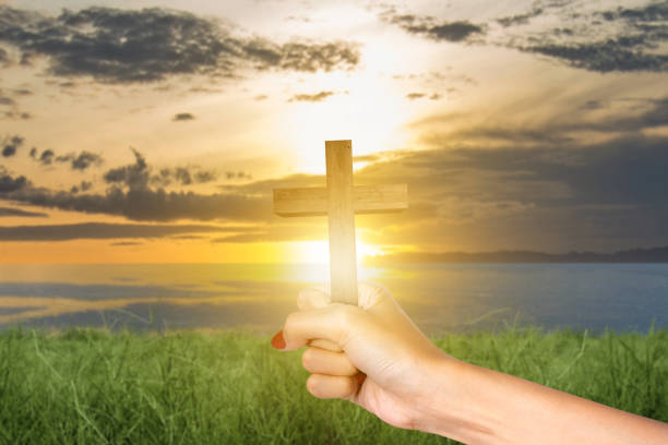 istock Human hand holding Christian cross 1479914871