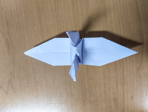 origami bird made of paper on a wooden background
