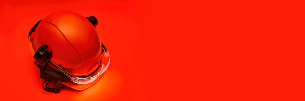 istock Protective goggles for eyes and construction helmet for head with earmuffs and headlamp on a red background. Construction tool and form for protection. 1479918869