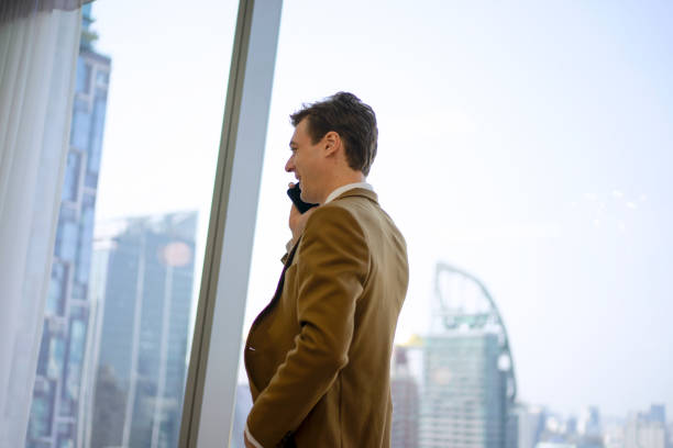 Business man talking with smart phone. Cityscape. Business and city life concept.
