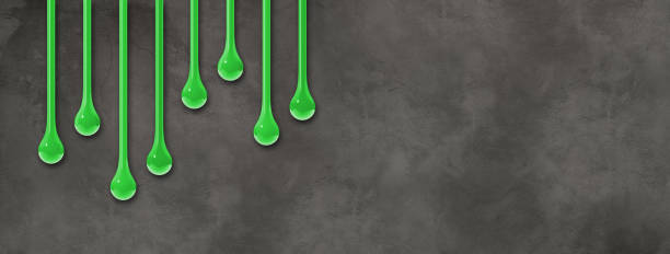 istock Green ink drops on dark concrete wall. Horizontal banner 1479927698