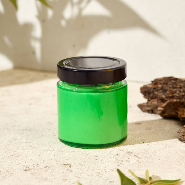 istock Green empty jar for cosmetics. Mockup for natural cosmetics. Nature composition with aromatic candle in jar. Mockup soy wax candle in natural style. Empty jar  with cosmetic product for design. 1479927749