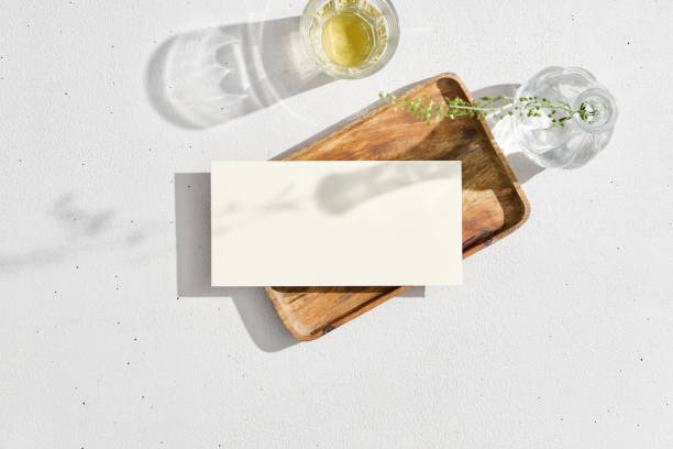 istock Real photo envelope template on white background. Lifestyle mock up paper envelope with empty place. Business design presentation mockup. Paper blank for your design with floral elements and glass. 1479927770