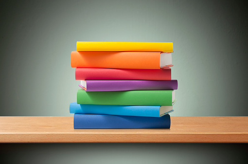 Stack of colored books on the shelf.