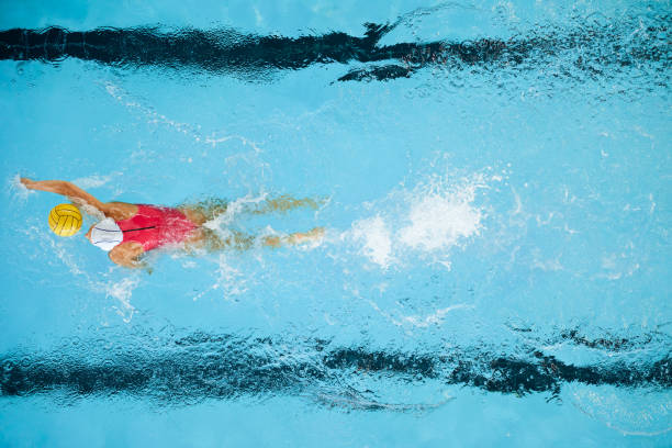 istock Female water polo player moving the ball forward 1479933347