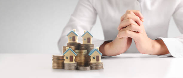 istock House Residential Structure in hand ,model house and coin 1479934904