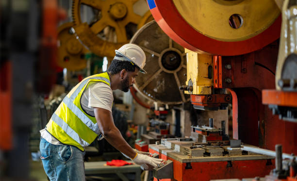 istock African American industrial worker is using hydraulic power press machine to make metal and steel part while working inside the metal sheet galvanized roof factory for safety industry concept 1479937632