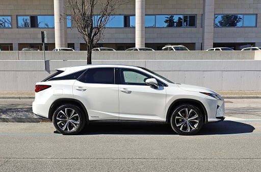 Udine, Italy. April 4, 2023. Lexus RX 450 hybrid at the roadside. It's a crossover SUV manufactured by the luxury division of Toyota.