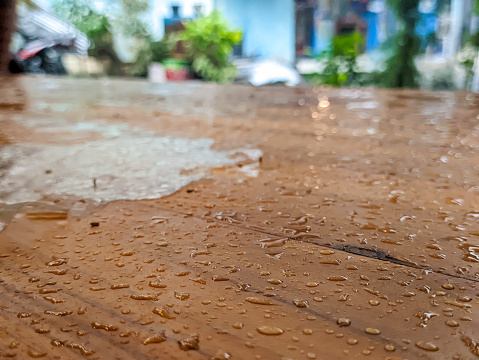 A close up of a wet brown table