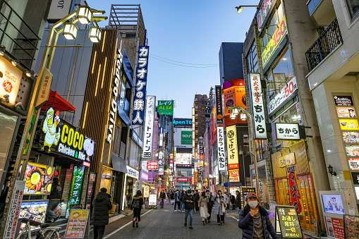 Tokyo, Japan - March 7, 2023: People on a street in the Kabukicho neighborhood in Shinjuku, Tokyo, Japan.