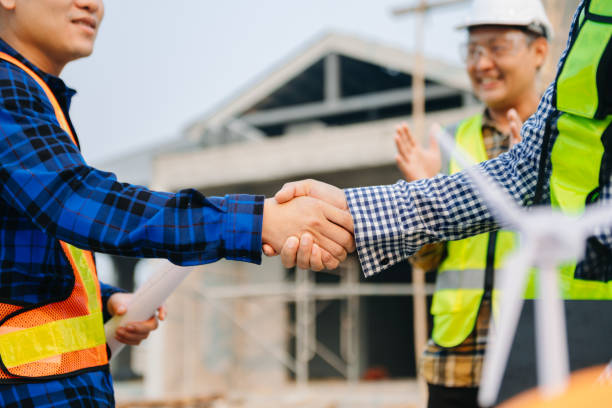 istock Engineer and contractor join hands after signing contract,They are having a modern building project together. successful cooperation concept 1479943099