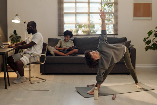 istock Young woman in activewear doing stretching exercise on mat 1479946984
