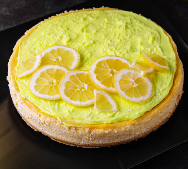 Layered Lemon Cheesecake on black plate