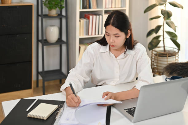 istock Focused female accountant preparing financial reports, analyzing work results at work desk. 1479951085