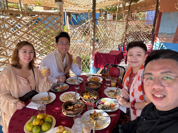 selfie asian chinese tourist enjoying moroccan food at tinghir restaurant patio outdoor dining  patio - shade people patio meat imagens e fotografias de stock