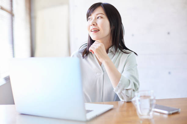 istock A beautiful, smiling Asian woman by the window. 1479958764