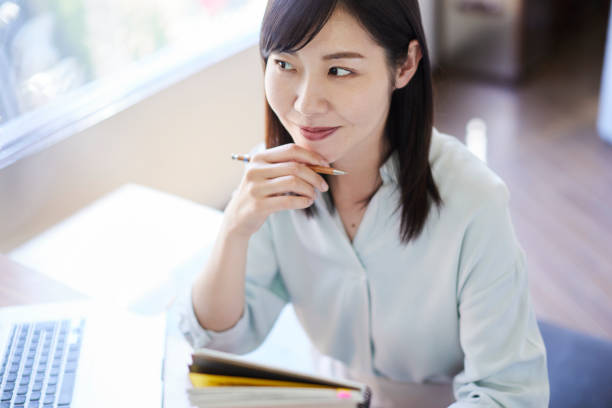 istock A beautiful, smiling Asian woman by the window. 1479958944
