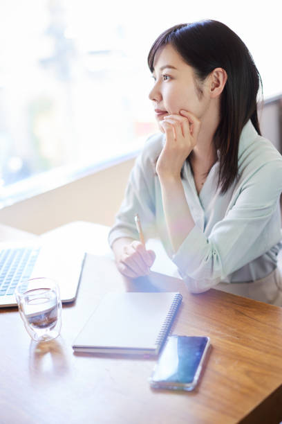 istock A beautiful, smiling Asian woman by the window. 1479959078