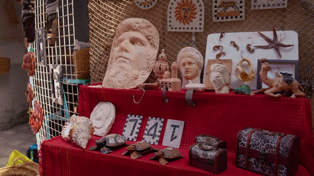 Sousse street market selling small clay figures and miscellaneous items.